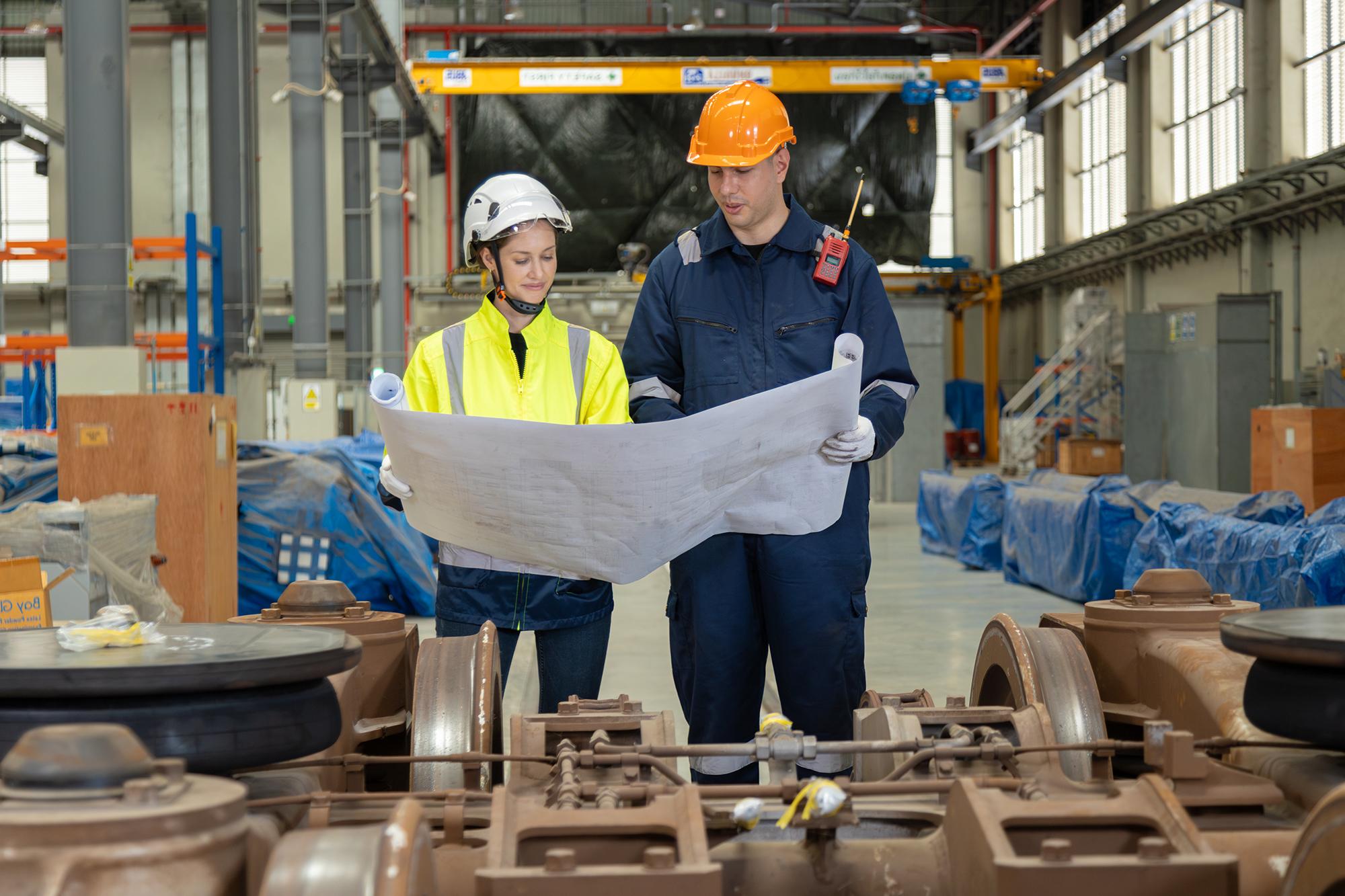 Two engineers looking over some blueprints